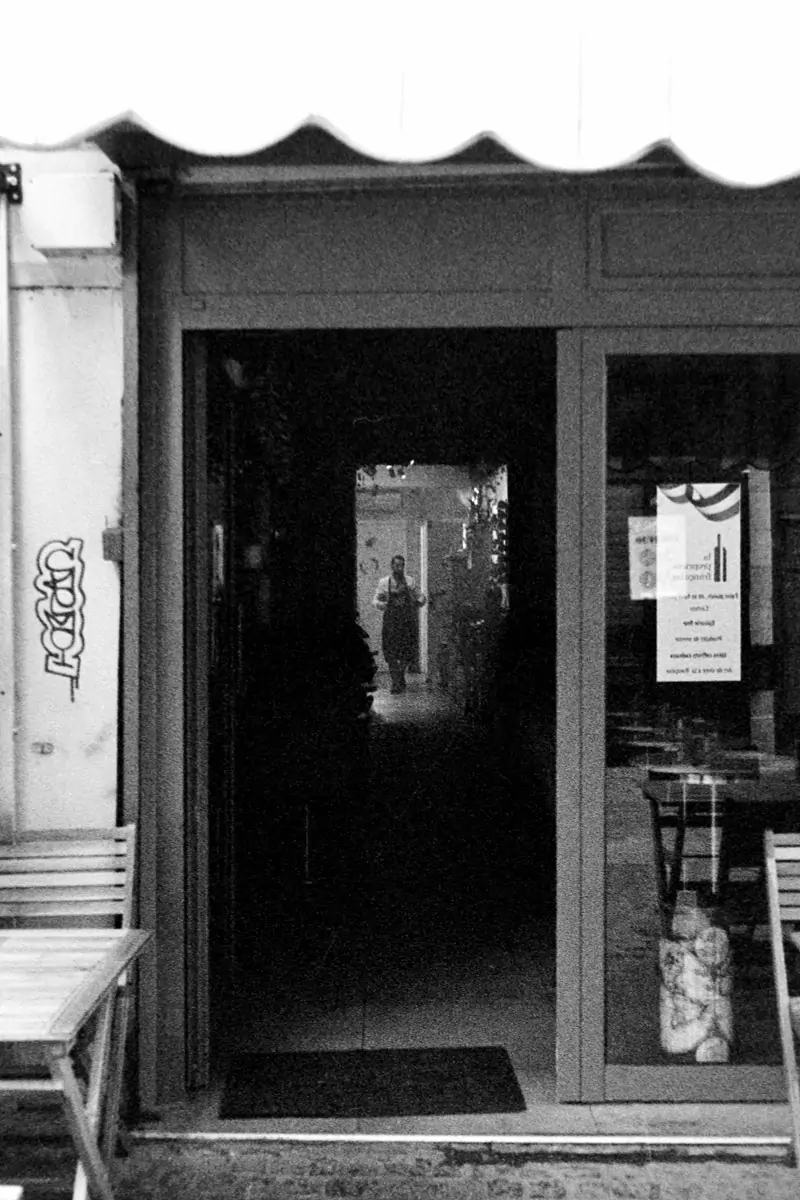 A view of chef starting his day through a bistro open door 